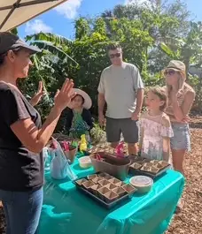 Melanie leading a hands-on garden learning session for a group