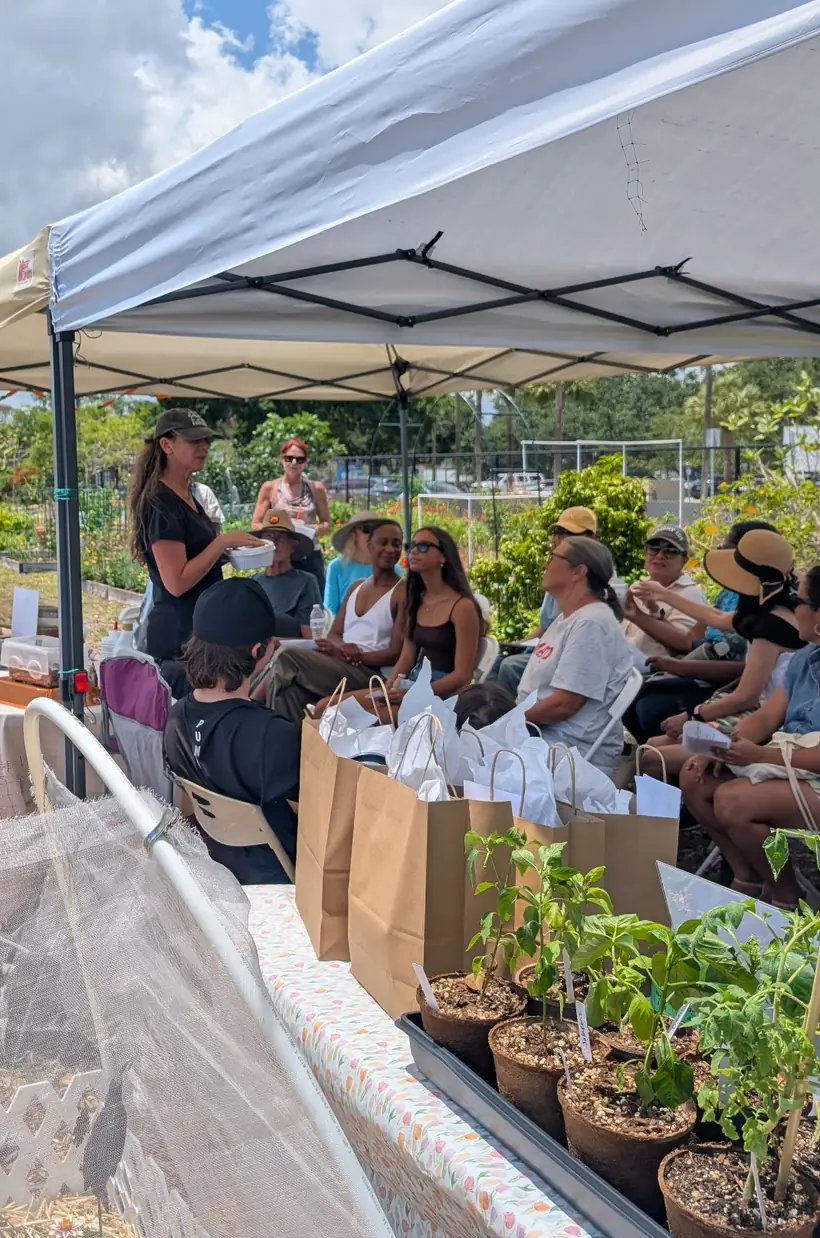 Melanie guiding participants at a garden workshop table