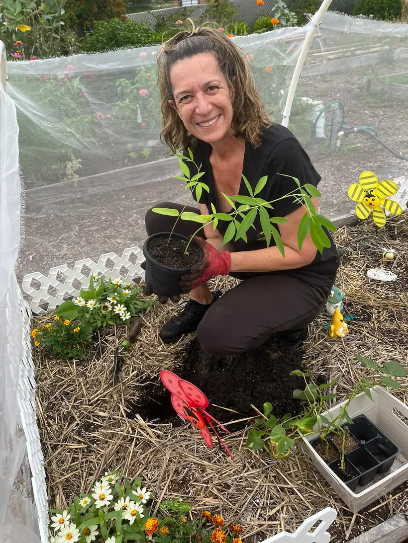 Melanie preparing seedlings during a garden session